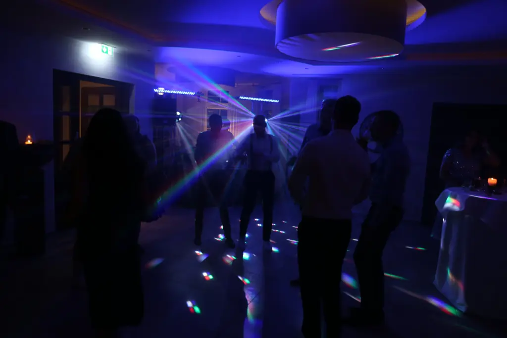 Tanzende Gäste unter Laserlicht